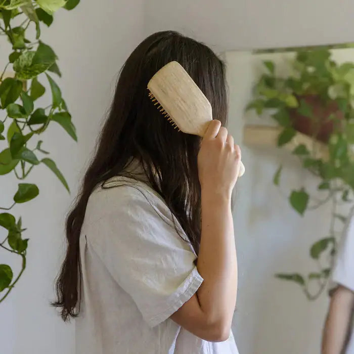 Sustainable bamboo hairbrush in use